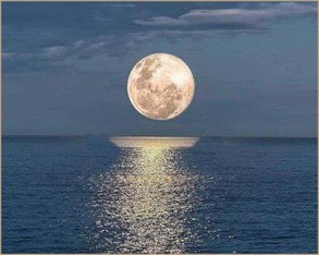 Picture of the moon above the ocean at night